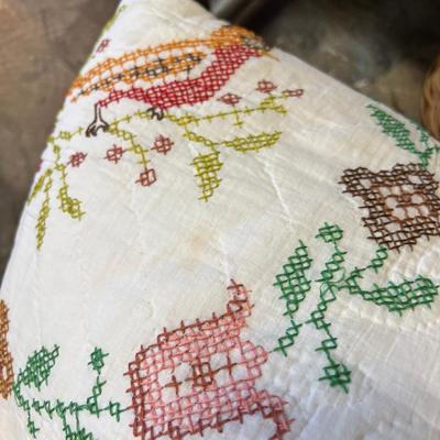 Wooden cabinet baskets full of antique quilts