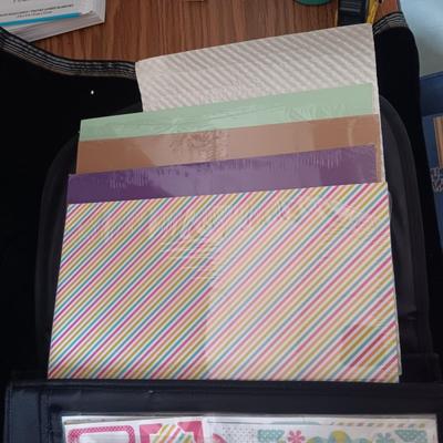 A LARGE SELECTION OF SCRAPBOOKING EMBELLISHMENTS AND PAPER