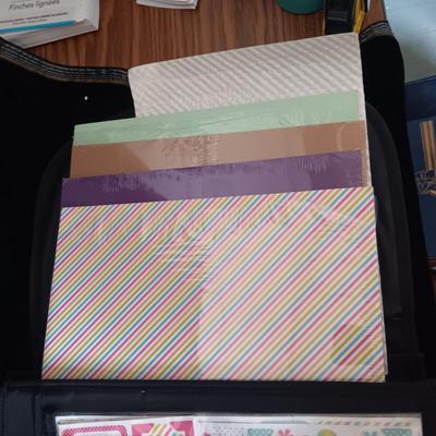 A LARGE SELECTION OF SCRAPBOOKING EMBELLISHMENTS AND PAPER