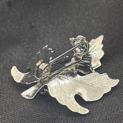 Silver tone leaf with black middle pin