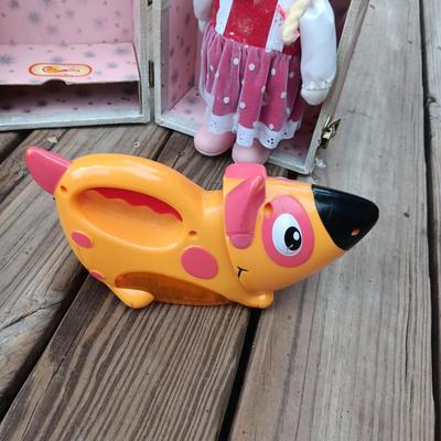 WIND UP MUSICAL DOLL, CARRY CASE, WOODEN DOLL CRADLE AND DOG FLASHLIGHT