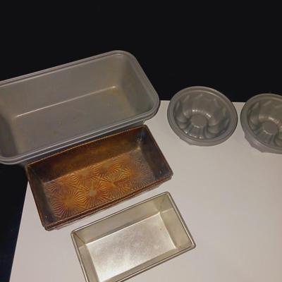 GLASS CUTTING BOARD, COOKIE PRESS, SMALL MOLDS AND LOAF PANS