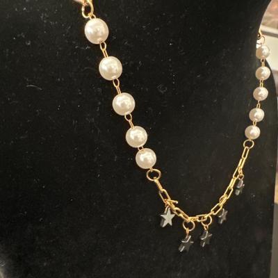 Super cute, gold, toned, pearl and black Dingle star necklace