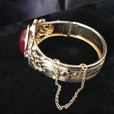 Gold tone locket Bracelet with red gem