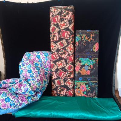 BOLTS OF SEWING MATERIAL AND A THROW BLANKET THAT FOLDS INTO ITSELF