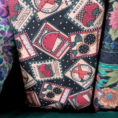 BOLTS OF SEWING MATERIAL AND A THROW BLANKET THAT FOLDS INTO ITSELF