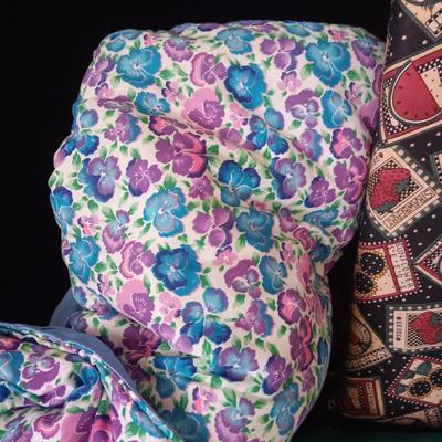 BOLTS OF SEWING MATERIAL AND A THROW BLANKET THAT FOLDS INTO ITSELF