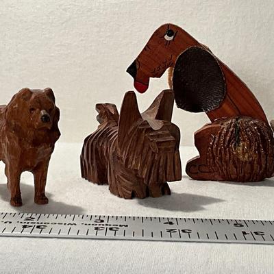 Trio of wood folk art carved dogs