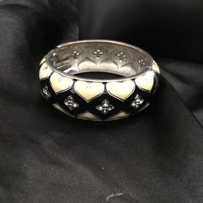 Silver tone crème and black bangle designed bracelet