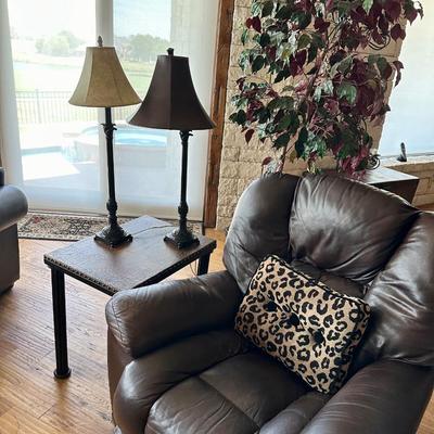 Lazy Boy Brown rocker recliner, 2 lamps, pillow, side table with iron legs and a faux tree