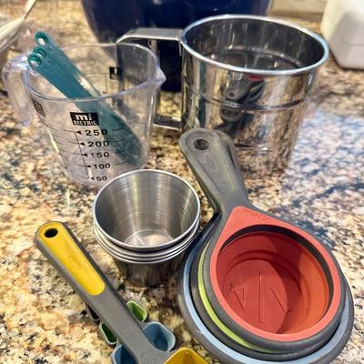 All measuring utensils, sifter and stainless cups