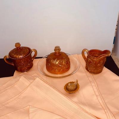 Beautiful Carnival Glass items and Miniature Nesting Hen Covered Dish with Peach Table Cloth