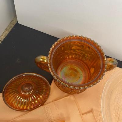 Beautiful Carnival Glass items and Miniature Nesting Hen Covered Dish with Peach Table Cloth