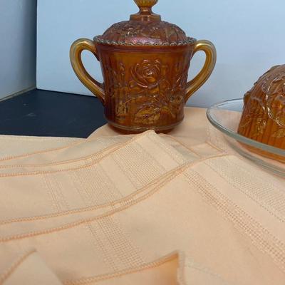 Beautiful Carnival Glass items and Miniature Nesting Hen Covered Dish with Peach Table Cloth
