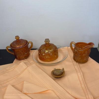 Beautiful Carnival Glass items and Miniature Nesting Hen Covered Dish with Peach Table Cloth