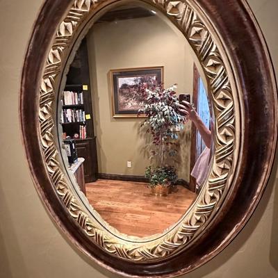 Oval mirror and table with glasses