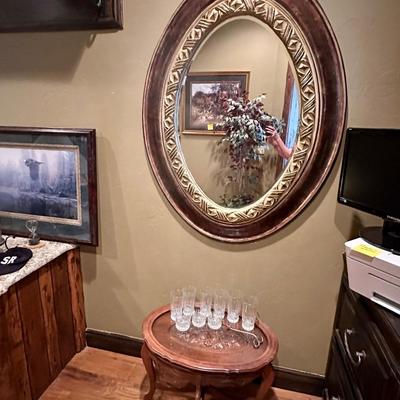Oval mirror and table with glasses