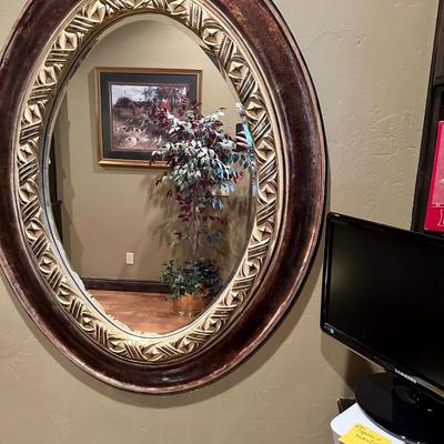 Oval mirror and table with glasses
