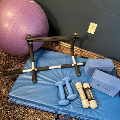 A collection of workout equipment, mats, weights, door hanger for pull ups and ball