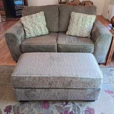 Ashley Furniture Industries Small Sofa with Footstool and two throw pillows