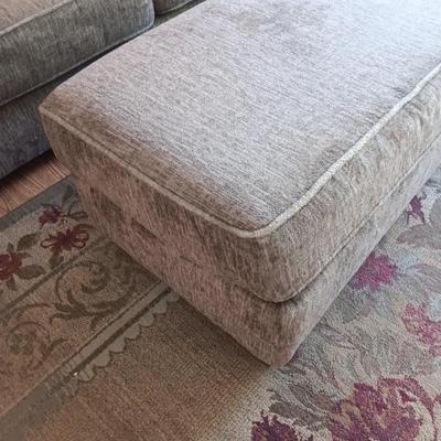 Ashley Furniture Industries Small Sofa with Footstool and two throw pillows