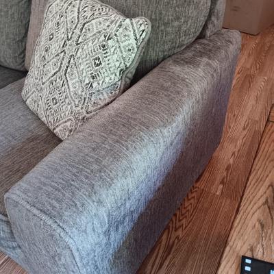 Ashley Furniture Industries Small Sofa with Footstool and two throw pillows