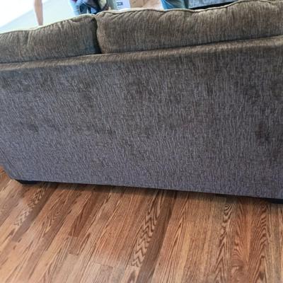 Ashley Furniture Industries Small Sofa with Footstool and two throw pillows
