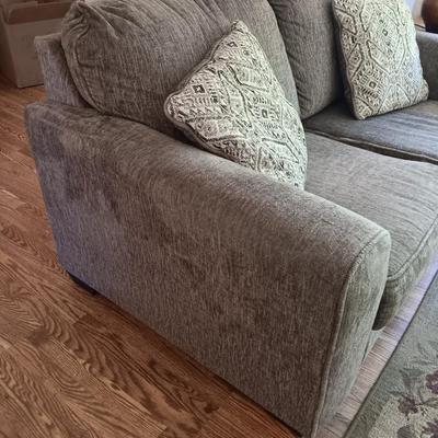 Ashley Furniture Industries Small Sofa with Footstool and two throw pillows