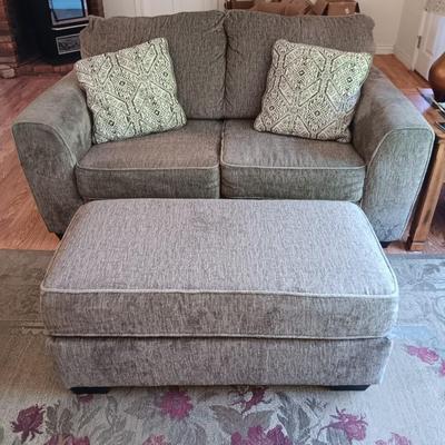 Ashley Furniture Industries Small Sofa with Footstool and two throw pillows