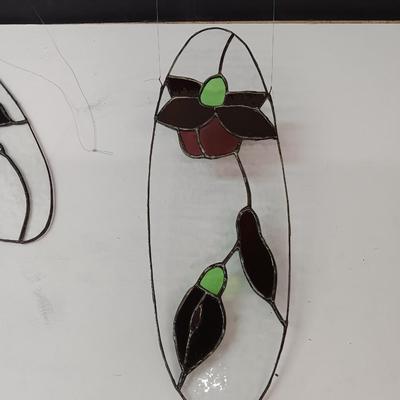 Two stained - glass floral window decor pieces