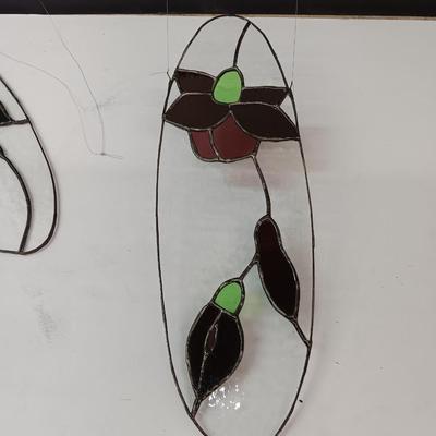 Two stained - glass floral window decor pieces