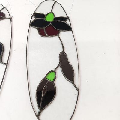 Two stained - glass floral window decor pieces