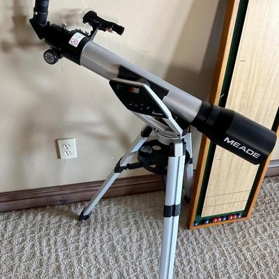 Telescope, small shuffleboard game and NY Yankees art