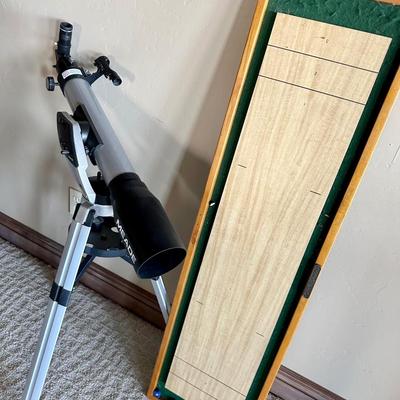 Telescope, small shuffleboard game and NY Yankees art