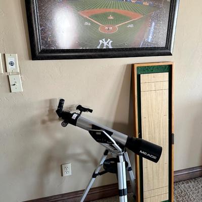 Telescope, small shuffleboard game and NY Yankees art