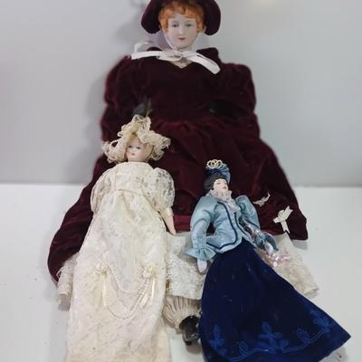 Three collectible dolls - porcelain with cloth bodies