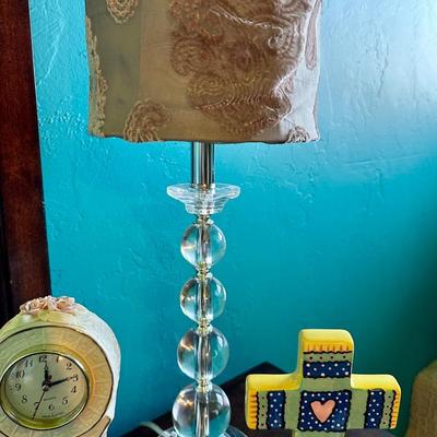 A trendy lamp To decorate any room. A clock, a cross, girl, figurines