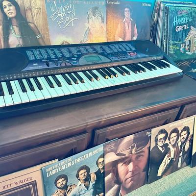 Vinyl records lot with small electric Keyboard