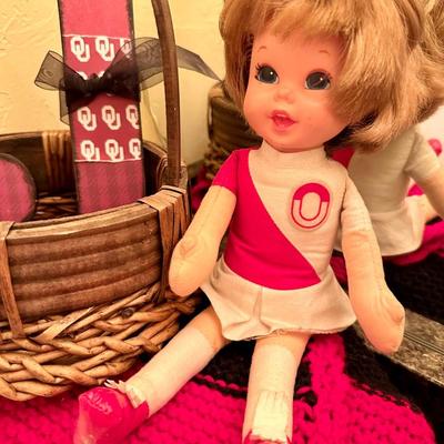 A vintage OU doll and OU, J initial a red and white blanket Including other decor items