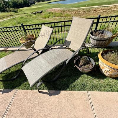 2 outdoor lounge chairs and 2 flower pots