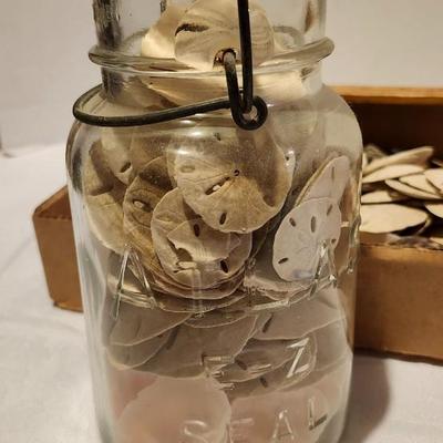 Vintage mason jar and sand dollars and rocks