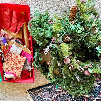 Christmas greenery and a tub full of Christmas decorations
