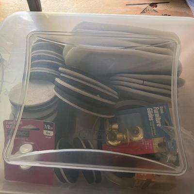 Tote of furniture sliders and feet