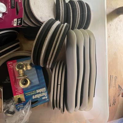 Tote of furniture sliders and feet
