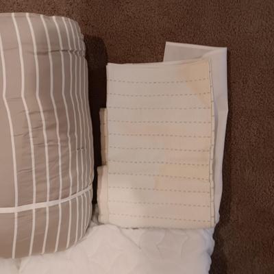 TWIN COMFORTER, BEDSKIRT, MATTRESS PADS, SHEETS AND 2 PANELS OF BLACKOUT CURTAINS