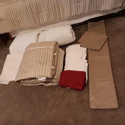 TWIN COMFORTER, BEDSKIRT, MATTRESS PADS, SHEETS AND 2 PANELS OF BLACKOUT CURTAINS