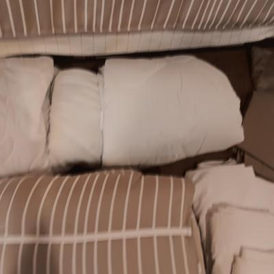 TWIN COMFORTER, BEDSKIRT, MATTRESS PADS, SHEETS AND 2 PANELS OF BLACKOUT CURTAINS