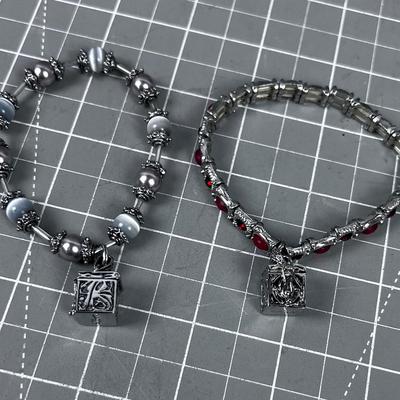 2 Bracelets with boxes that open on them 