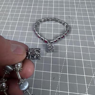 2 Bracelets with boxes that open on them 