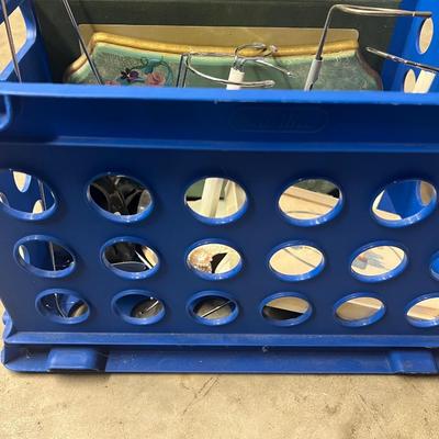 Blue crate with doll books and supplies